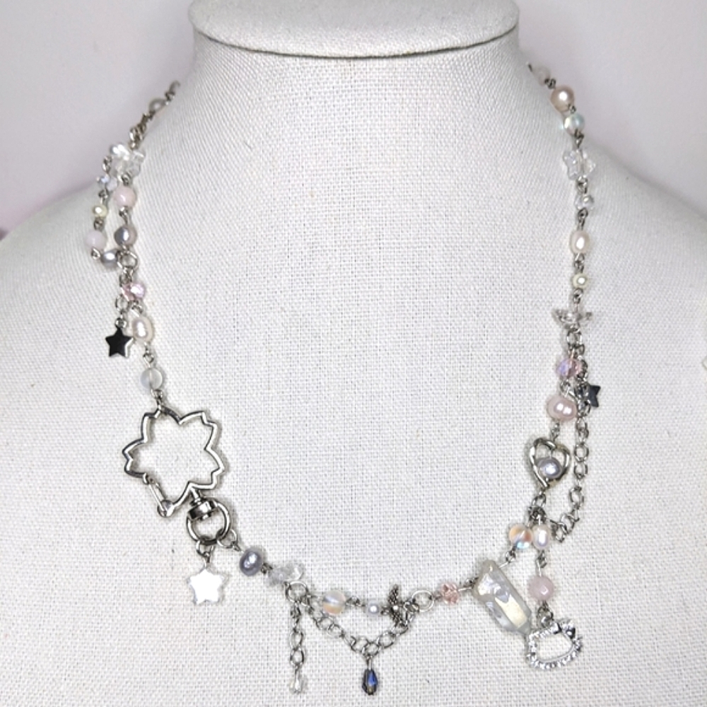 This necklace is chery blossom inspired with chain and charms. Handmade by me.